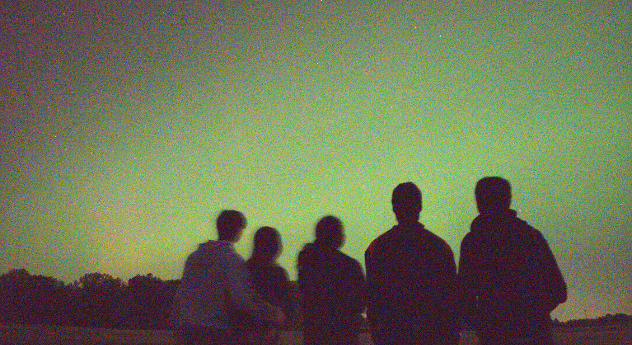 Silhouettes beneath an aurora near Purdue University