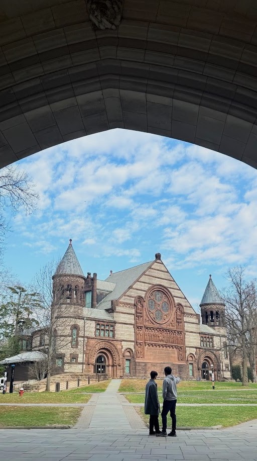 Campus buildings framed by a stone archway