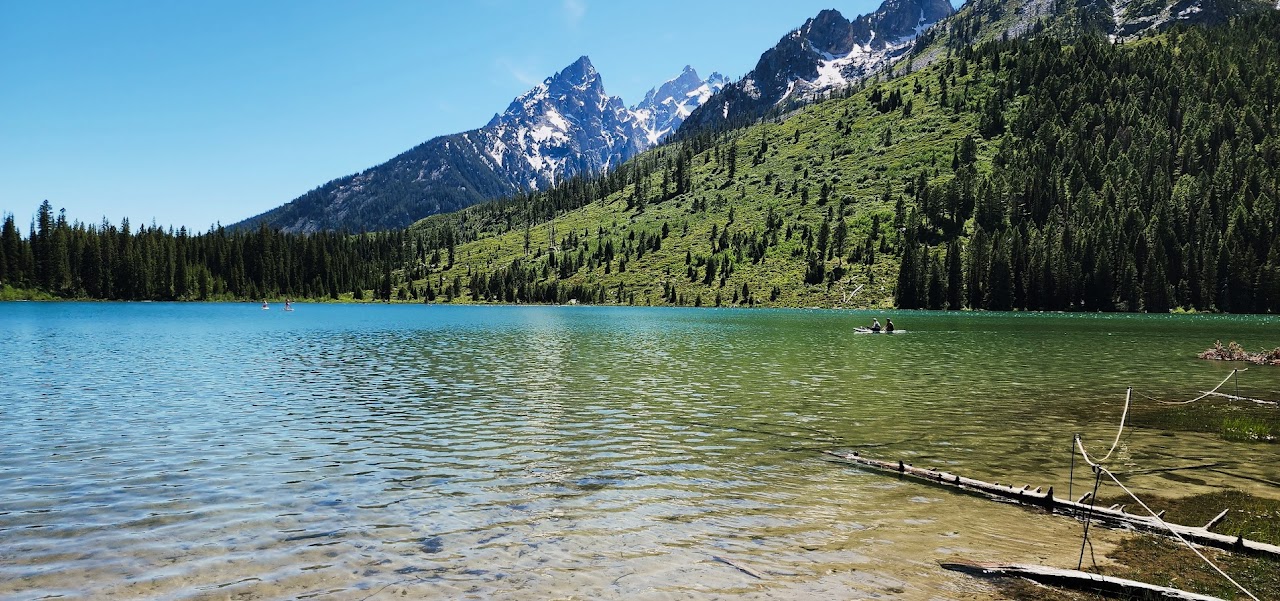 Clear lake beneath a mountain range